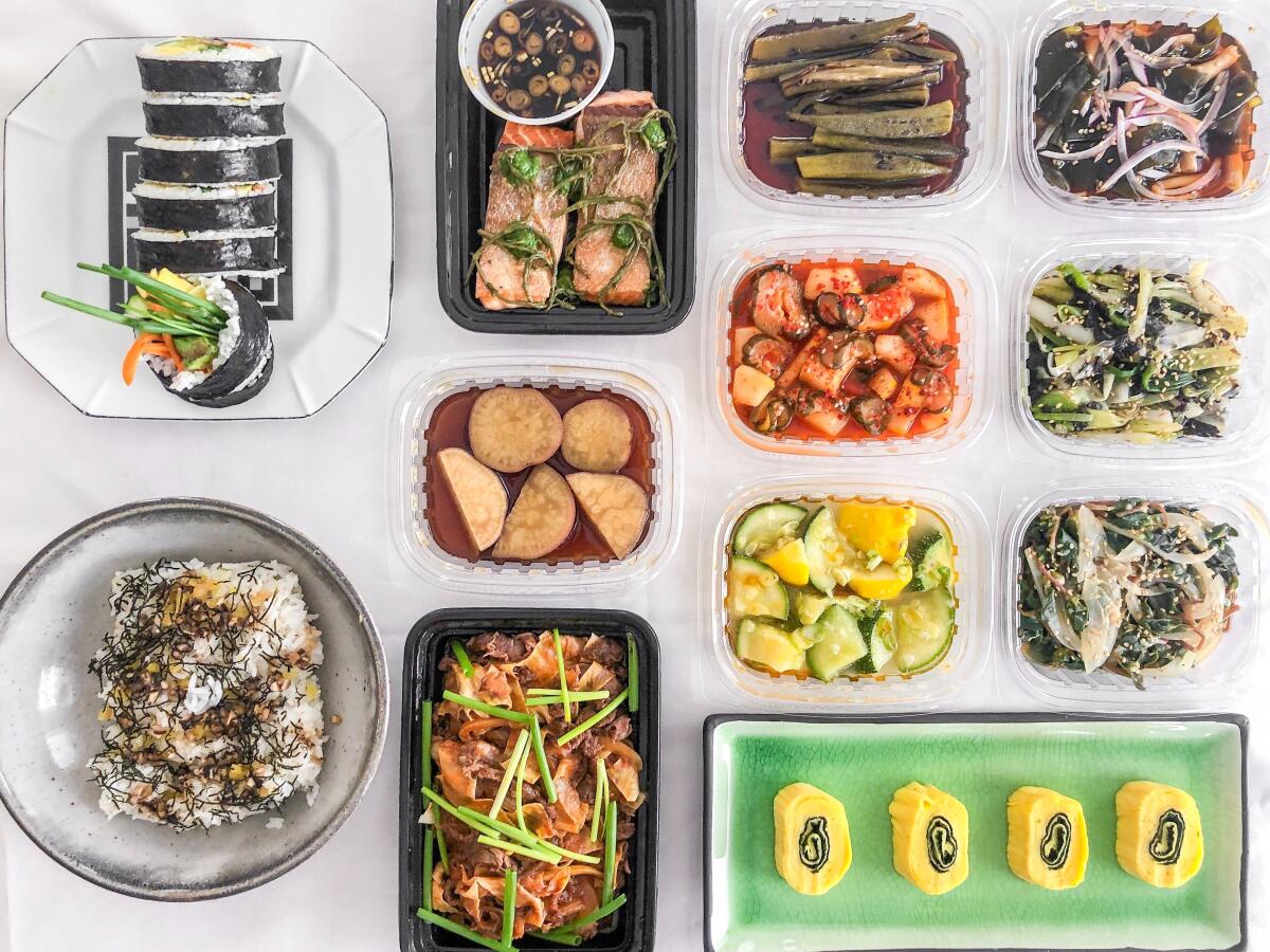 Takeout containers of food arranged against a white background.