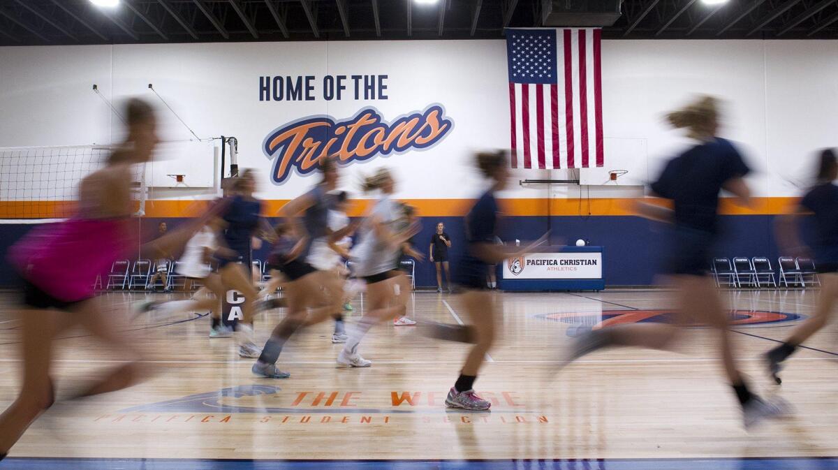 Pacifica Christian School girls’ volleyball players run lines during practice on Tuesday. Entering their second year, the Tritons are transitioning to varsity sports.