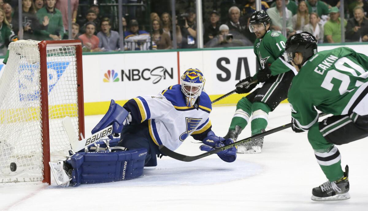 Blues goalie Brian Elliott (1) defends the goal against Stars left wing Patrick Sharp (10) and center Cody Eakin (20) during the first period of Game 5 on Saturday.