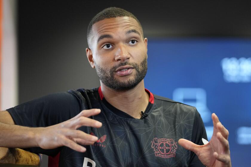 Bayer Leverkusen defender Jonathan Tah talks to The Associated Press during an interview at the BayArena in Leverkusen, Germany, Wednesday, April 24, 2024. Tah won the Bundesliga title already, and has also the chance to win the German Cup and the Europa League this season with Leverkusen. Tah is also defender for Germany's national team. (AP Photo/Martin Meissner)