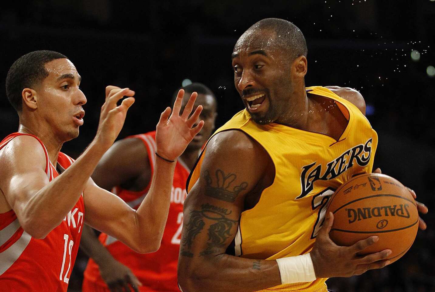 Lakers guard Kobe Bryant spins away from Rockets guard Kevin Martin before elevating for a shot in the fourth quarter Tuesday night at Staples Center.