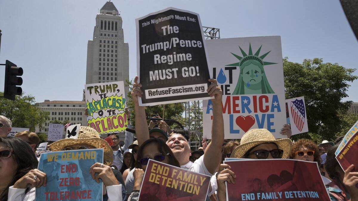 Protesters gather downtown Saturday to demonstrate against President Trump's immigration policies and to push his administration to swiftly reunite families who were separated under his "zero-tolerance" border crossing policy.