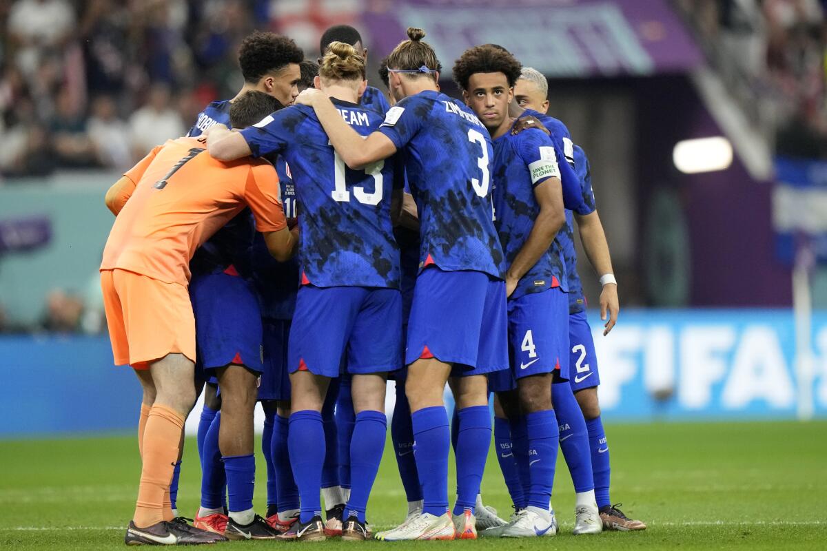 American players gather on the pitch at the start of the second half of a World Cup game.