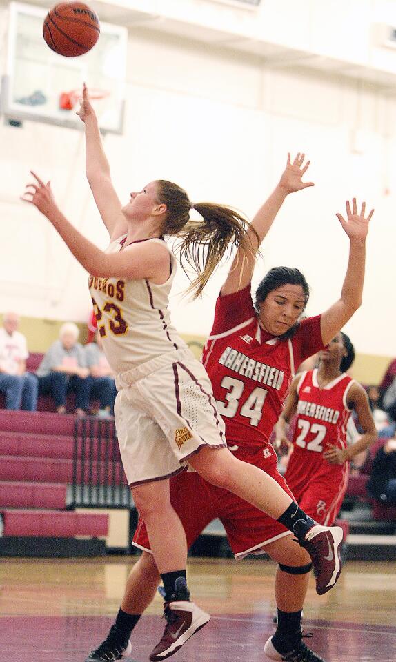 GCC's Samantha Pyros scores a point past Bakersfield's Giselle Flores during a game on Wednesday, January 22, 2014.
