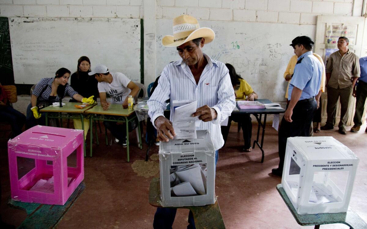 A man casts his ballot during general elections in Catacamas, Honduras, on Sunday. Hondurans are choosing a new president in a country reeling from violence, poverty and the legacy of a 2009 coup.