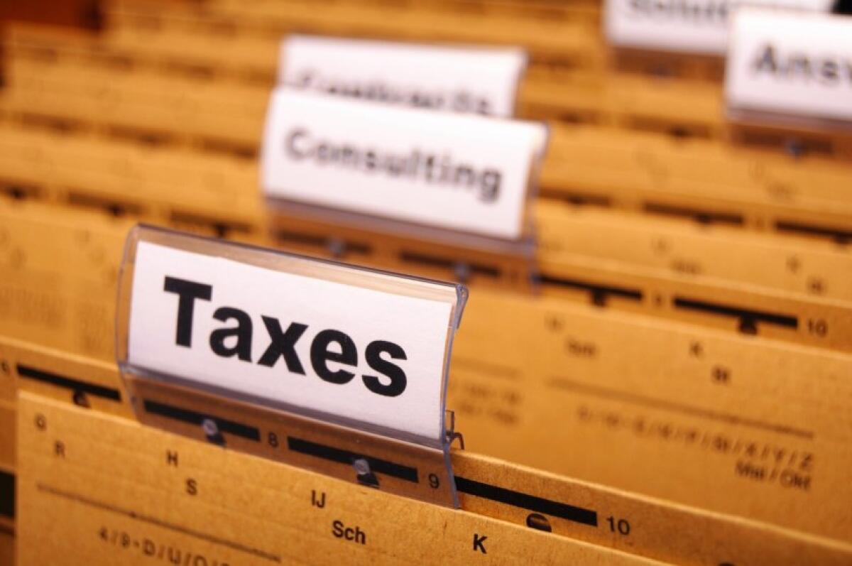A set of file folders including one labeled "Taxes"