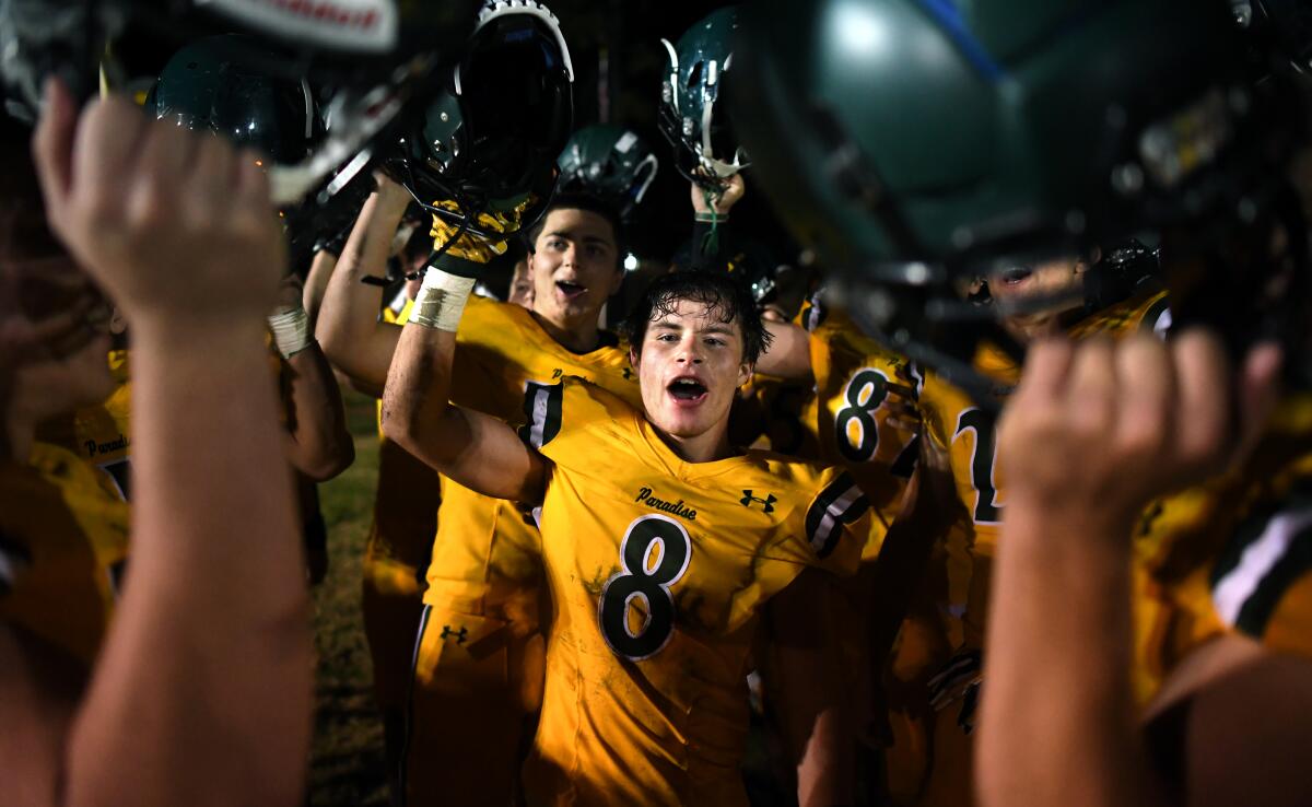 Paradise running back Brenden Moon, center, celebrates with teammates after the Bobcats' season-opening win.