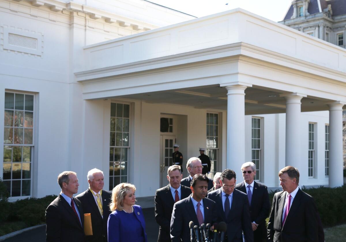 Louisiana Gov. Bobby Jindal speaks while flanked by members of the National Governors Assn., after a meeting Monday with President Obama at the White House.