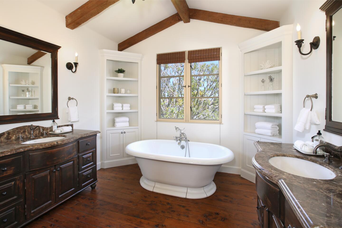 A standing tub, wood beam ceilings and corner built-ins.