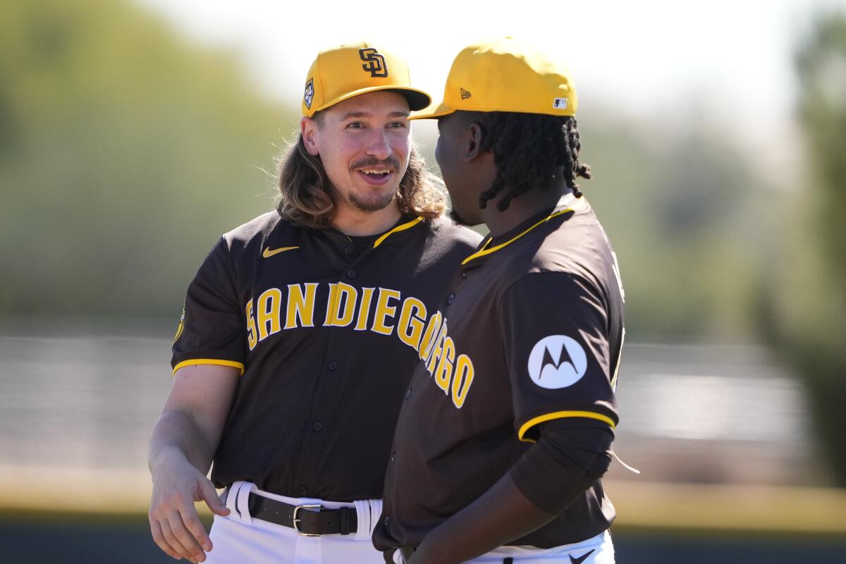 Padres pitchers Lake Bachar, left, and, Moises Lugo, right, talk during spring training 
