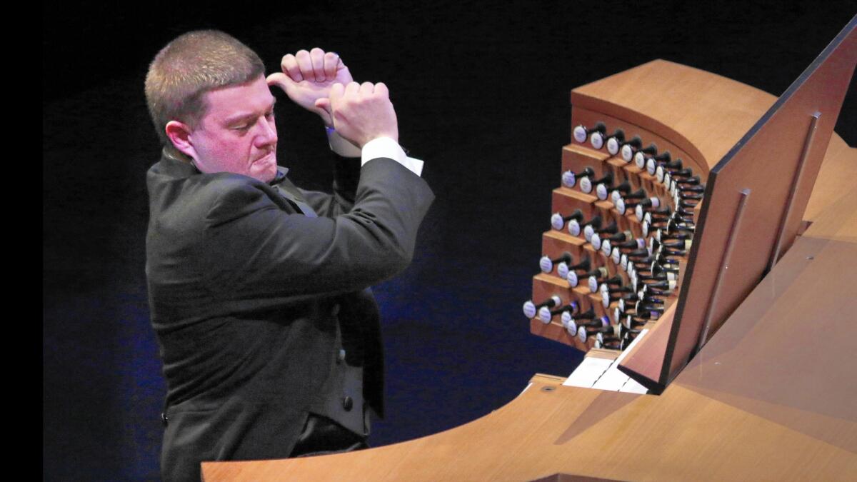 Organ soloist Aaron David Miller performs for the happy-birthday Hurricane Mama festivities.