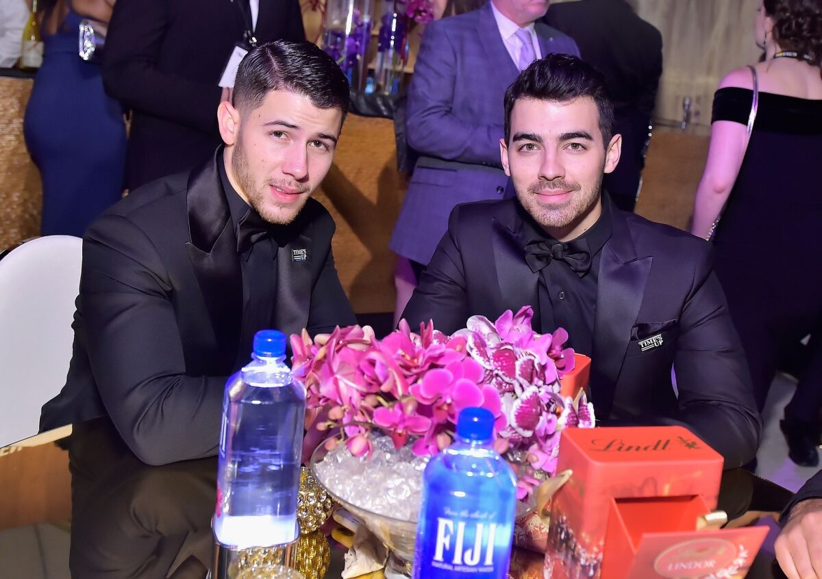 Nick Jonas, left, and Joe Jonas attend the HFPA's after-party on Sunday.