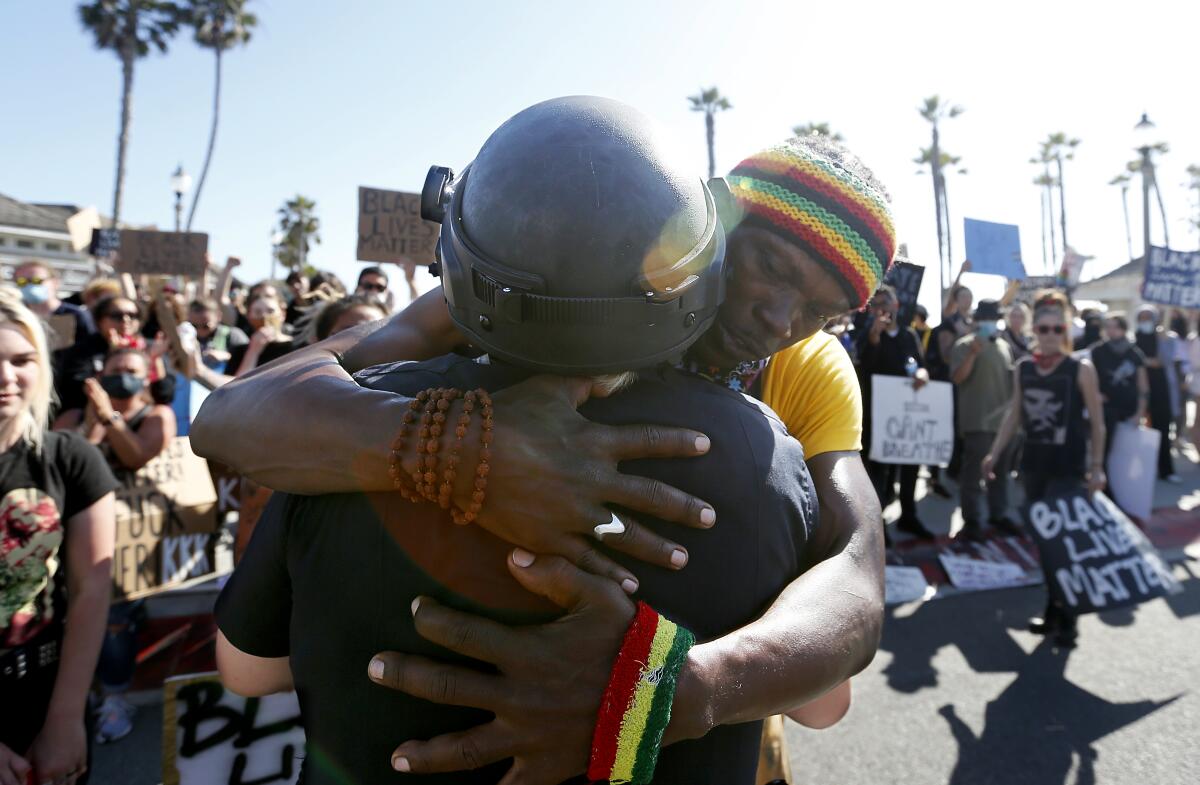 David Blackgold hugs Huntington Beach police officer K. Wood.