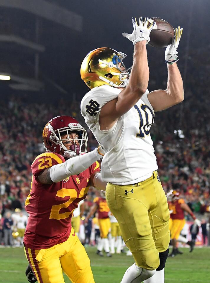 Notre Dame receiver Chris Finke catches a touchdown pass in front of USC's Jonathan Lockett in the second quarter at the Coliseum.