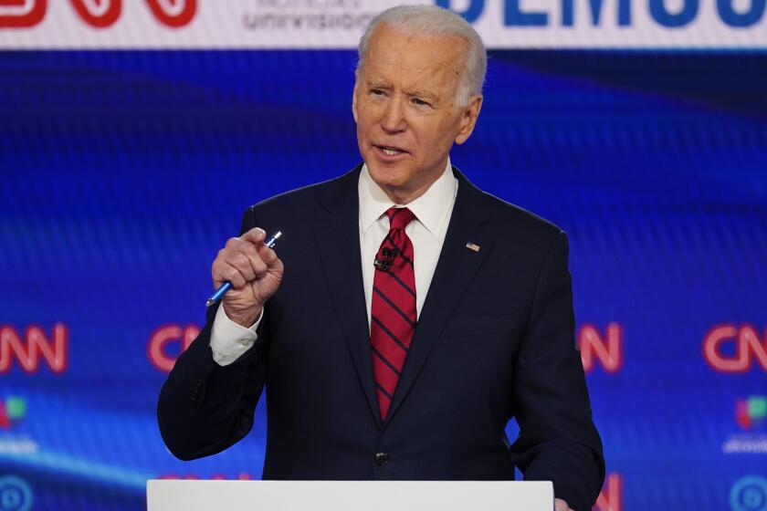 In this March 15, 2020, photo, Sen. Bernie Sanders, I-Vt., and former Vice President Joe Biden, participate in a Democratic presidential primary debate at CNN Studios in Washington. A former aide to Biden is accusing the presumptive Democratic presidential nominee of sexually assaulting her during the early 1990s when he was a senator. Biden's campaign denies the charges. (AP Photo/Evan Vucci)