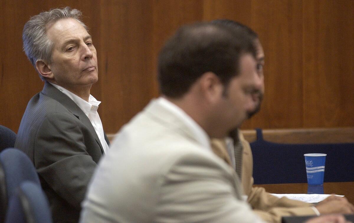 In this Aug. 18, 2003, file photo, Robert Durst, left, sits in a courtroom during a pretrial hearing at the Galveston County Courthouse in Galveston, Texas.