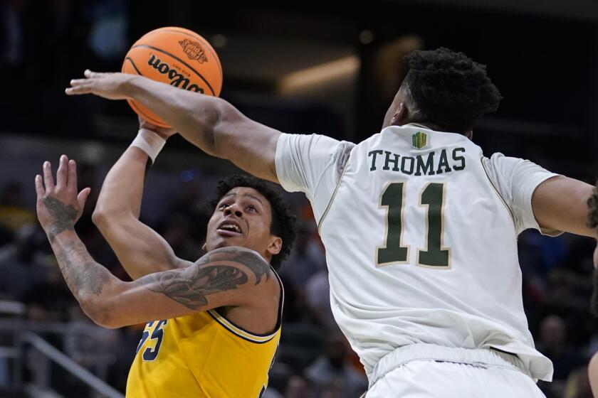 Michigan guard Eli Brooks shoots over Colorado State forward Dischon Thomas (11) during the second half of a college basketball game in the first round of the NCAA tournament in Indianapolis, Thursday, March 17, 2022. (AP Photo/Michael Conroy)