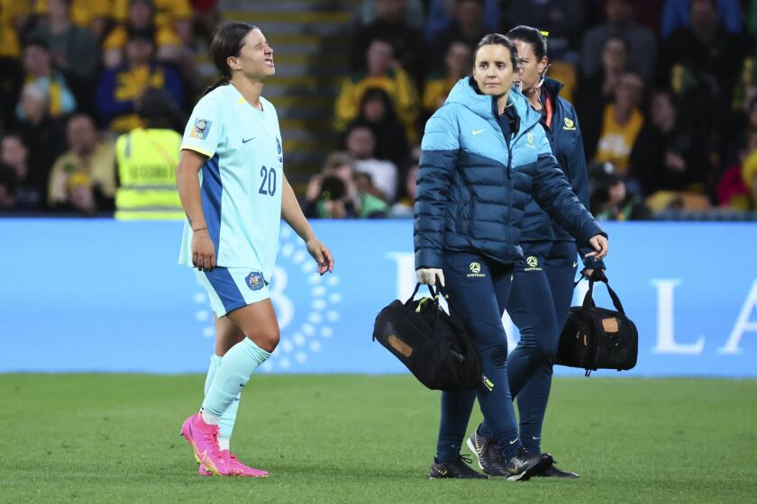 FILE - Australia's Sam Kerr reacts after she was injured in a tackle during the Women's World Cup third place playoff soccer match between Australia and Sweden in Brisbane, Australia, on Aug. 19, 2023. An English study into the causes of knee injuries to women soccer players was launched on Tuesday April 30, 2024. ‘Project ACL’ will focus on players in the Women's Super League in England as part of a three-year study into an injury that is suffered by a disproportionate number of female players compared to their male counterparts. (AP Photo/Tertius Pickard, File)