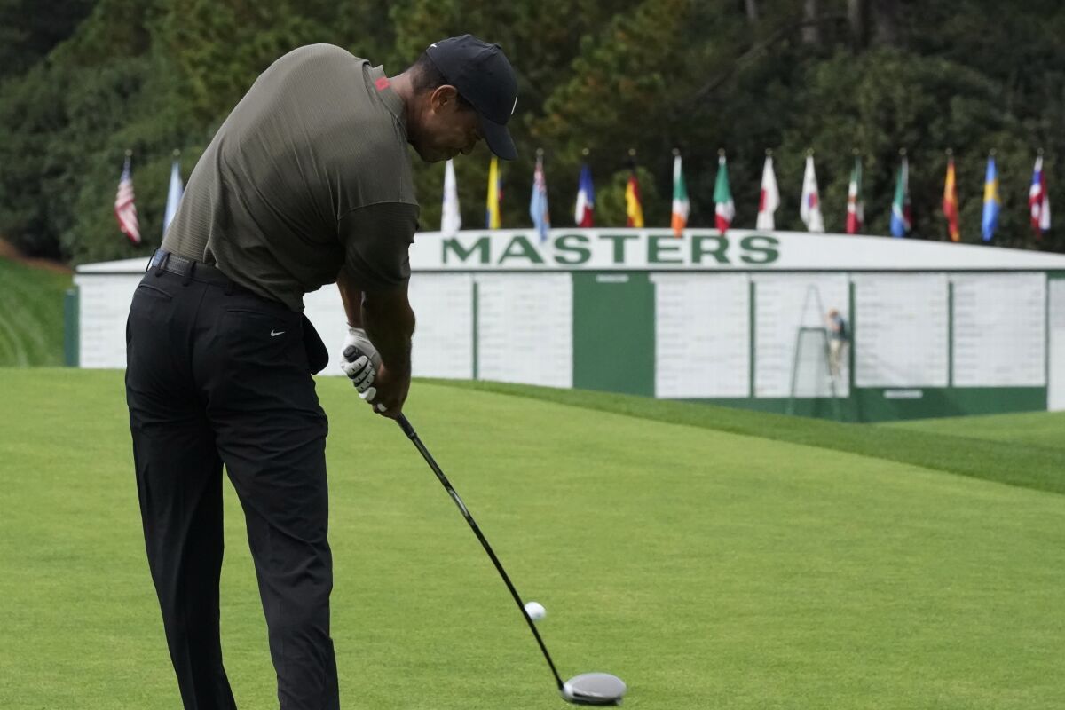 Tiger Woods tees off on the first hole during the first round of the Masters golf tournament Thursday, Nov. 12, 2020, in Augusta, Ga. (AP Photo/David J. Phillip)