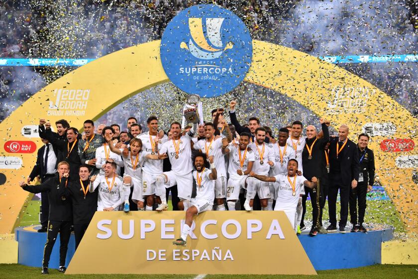 TOPSHOT - Real Madrid's players celebrate after winning the Spanish Super Cup final between Real Madrid and Atletico Madrid on January 12, 2020, at the King Abdullah Sports City in the Saudi Arabian port city of Jeddah. (Photo by Giuseppe CACACE / AFP) (Photo by GIUSEPPE CACACE/AFP via Getty Images)