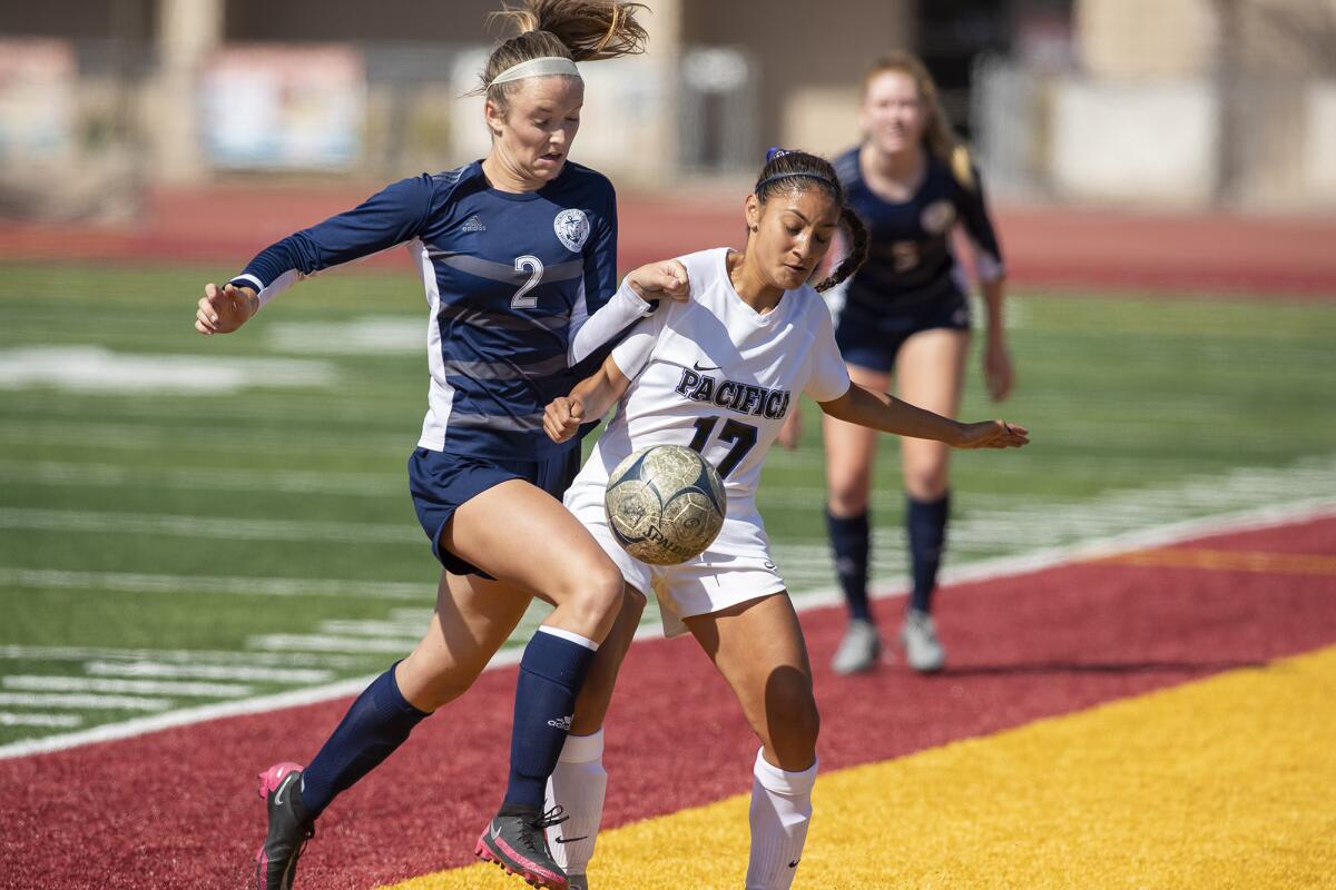 Newport Harbor's Laine Briggs battles for a ball against Pacifica's Lizbeth De Loera in a Division 1 playoff game on Friday.