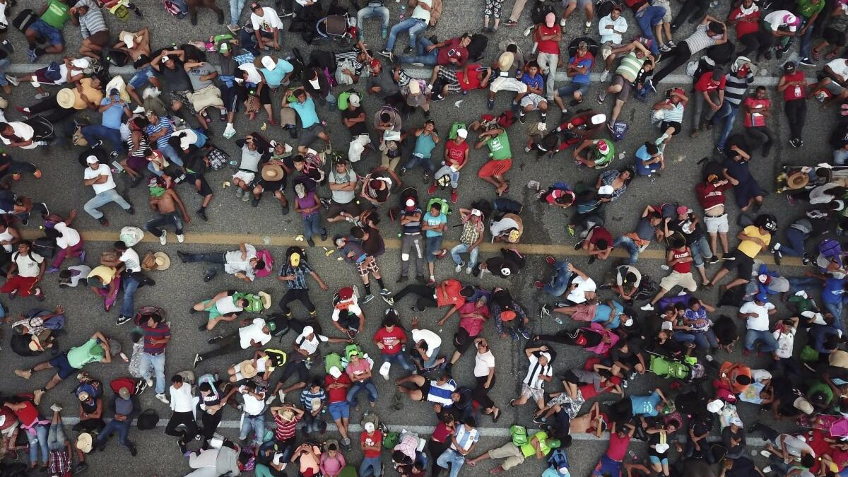 Members of the migrant caravan bound for the United States rest outside of Arriaga, Mexico on Oct. 27.