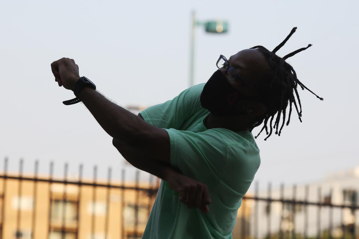 Martel Jackson practices a dance routine in the parking lot of a dance studio in North Hollywood.