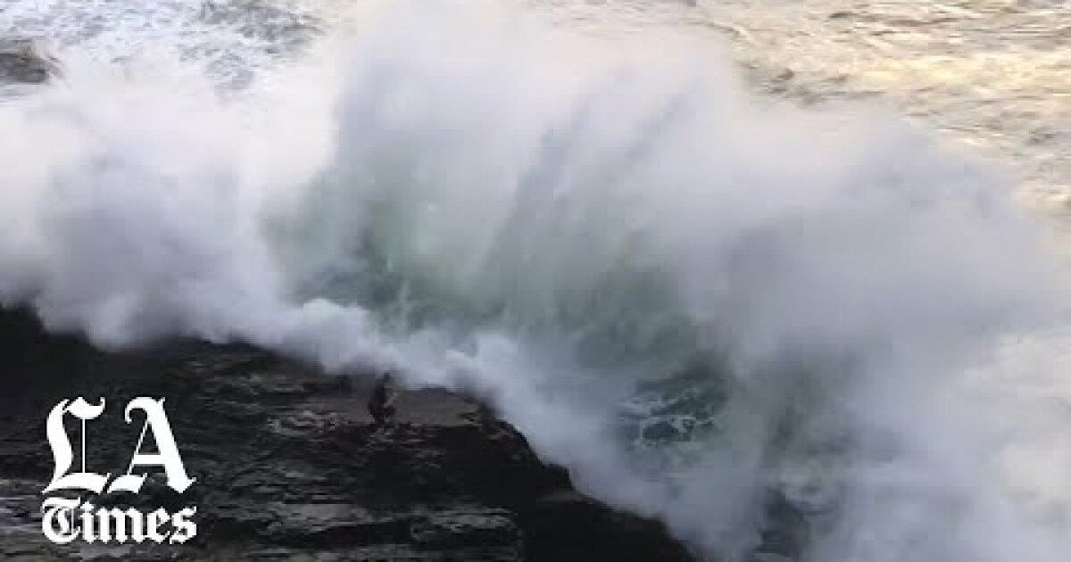 Watch a huge wave knock a man off a rock into the ocean near Santa Cruz