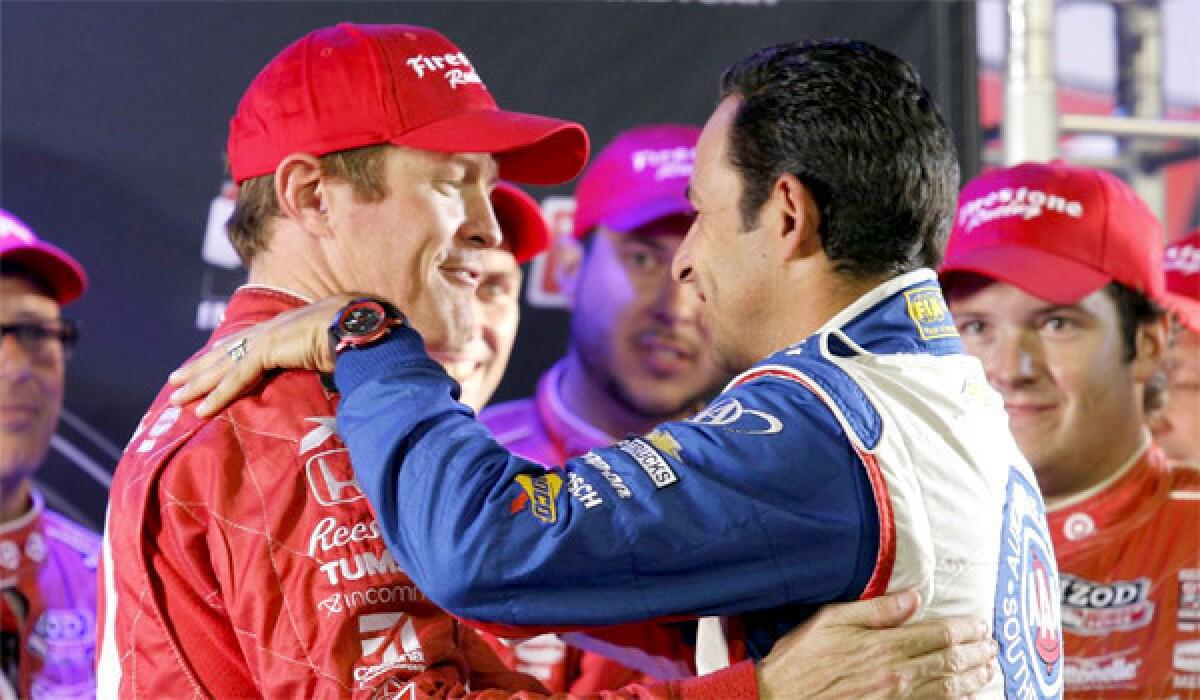 Helio Castroneves, right, congratulates Scott Dixon, left, after his fifth place finish in the MAVTV 500 race at Fontana to claim his third IndyCar title. Castroneves finished second in the standings behind Dixon by 27 points.