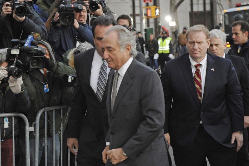 FILE - Bernard Madoff arrives at Manhattan federal court, Thursday, March 12, 2009, in New York. Madoff, the financier who pleaded guilty to orchestrating the largest Ponzi scheme in history, died early Wednesday, April 14, 2021, in a federal prison, a person familiar with the matter told The Associated Press. (AP Photo/ Louis Lanzano, File)