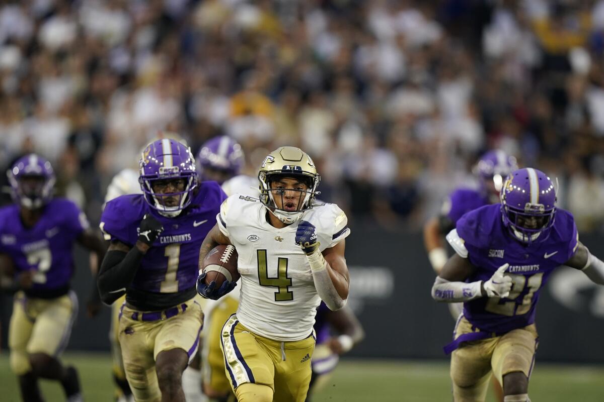 Georgia Tech running back Dontae Smith (4) runs the ball before scoring a touchdown in the first half of an NCAA college football game against Western Carolina, Saturday, Sept. 10, 2022, in Atlanta. (AP Photo/Brynn Anderson)