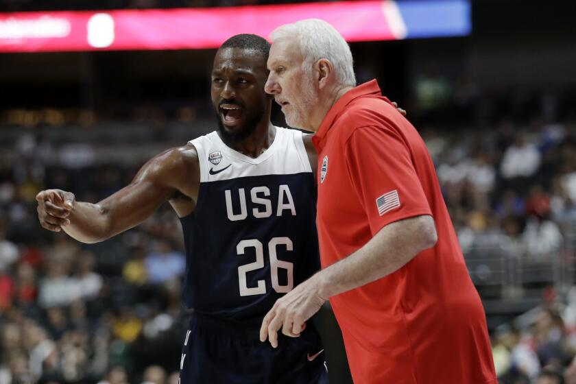 United States' Kemba Walker, left, talks to coach Gregg Popovich during the first half of the team's exhibition basketball game against Spain on Friday, Aug. 16, 2019, in Anaheim, Calif. (AP Photo/Marcio Jose Sanchez)