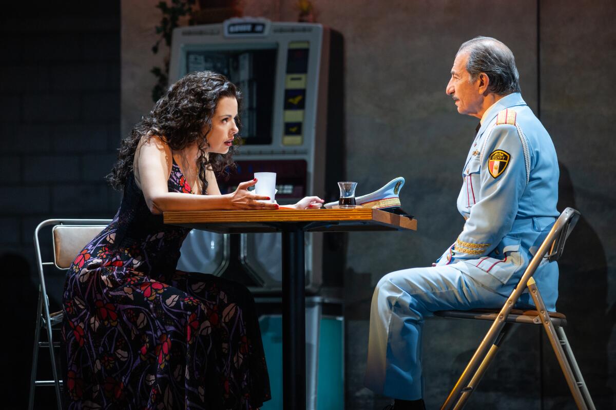  Janet Dacal and Sasson Gabay are seen sitting around a table on stage