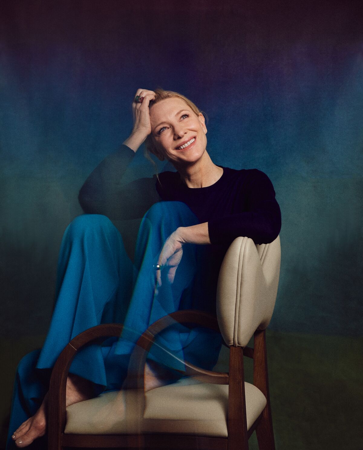 a woman has her legs up in a chair and smiles