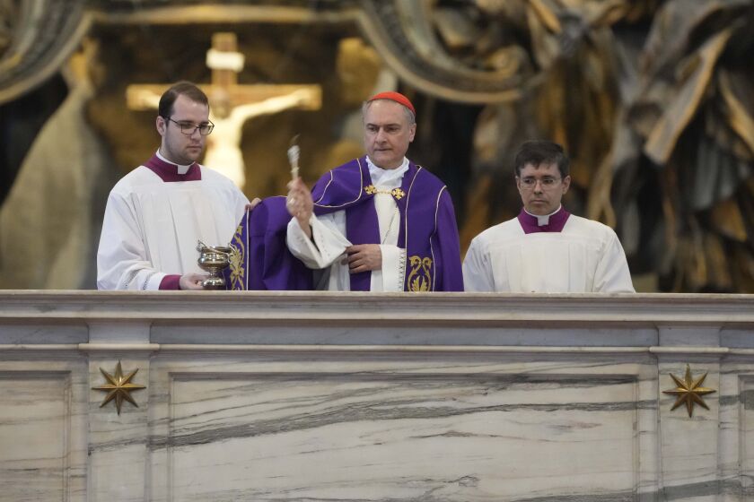 Cardinal Mauro Bassetti, center, blesses the altar of the confession during a penitential rite inside St. Peter's Basilica, Saturday, June 3, 2023. (AP Photo/Gregorio Borgia)