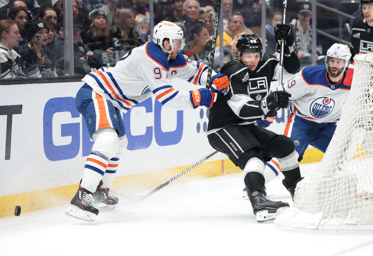 Kings forward Blake Lizotte battles for the puck with Edmonton Oilers star Connor McDavid.