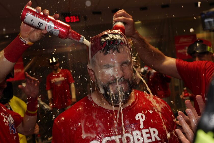 Philadelphia Phillies' Kyle Schwarber celebrates after the Phillies won a baseball game against the Houston Astros to clinch a wild-card playoff spot, Monday, Oct. 3, 2022, in Houston. (AP Photo/David J. Phillip)