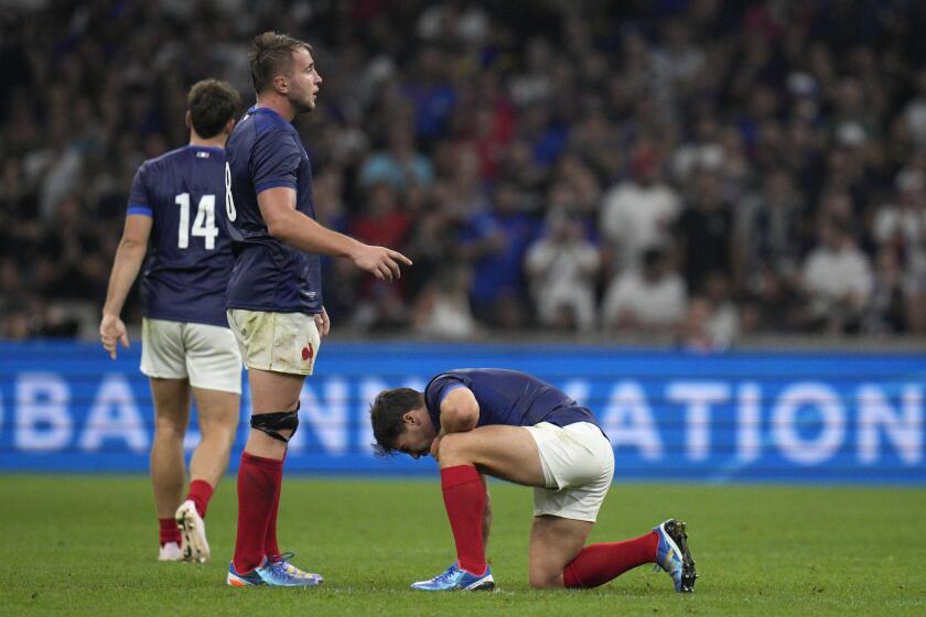 France's Anthonhy Jelonch checks on teammate Antoine Dupont after he was injured in a collision during the Rugby World Cup Pool A match between France and Namibia at the Stade de Marseille in Marseille, France, Thursday, Sept. 21, 2023. (AP Photo/Daniel Cole)