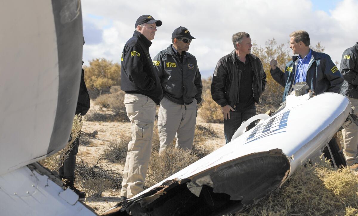 Investigators with the National Transportation Safety Board on Saturday survey the site where Virgin Galactic's SpaceShipTwo crashed in the Mojave Desert.