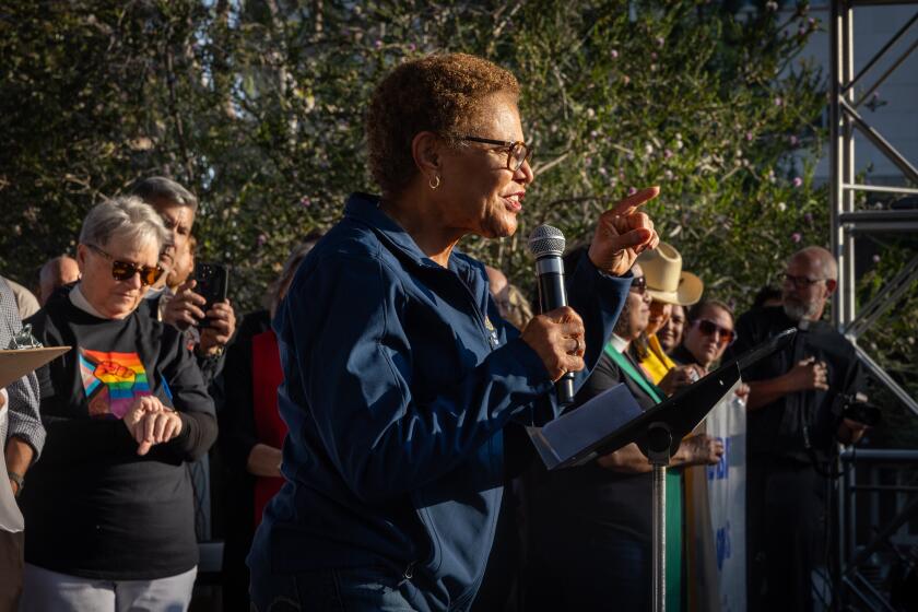 Los Angeles, CA - June 10: Mayor Karen Bass gathers with faith leaders lead a prayer vigil in Grand Park to stand in support of community members facing immigration raids as protesters continue to clash with law enforcement in downtown Los Angeles due to the immigration raids in L.A. on Tuesday, June 10, 2025 in Los Angeles, CA. (Jason Armond / Los Angeles Times)