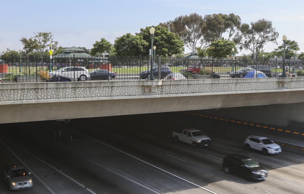 The Teralta Park freeway lid includes a grassy area and trees