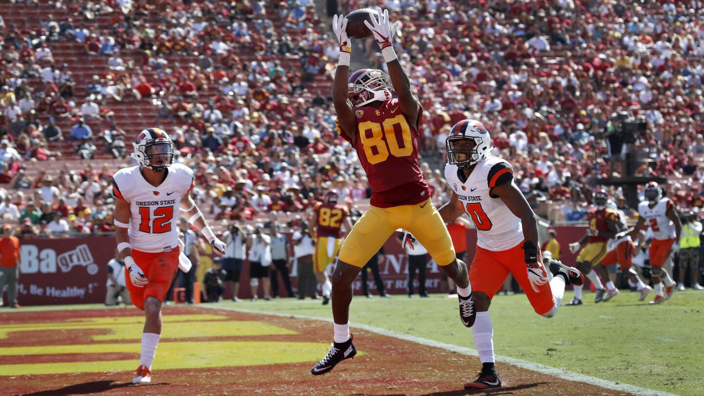 USC wide receiver Deontay Burnett catches a touchdown pass against Oregon State safeties David Morris and Omar Hicks-Onu during the second quarter.