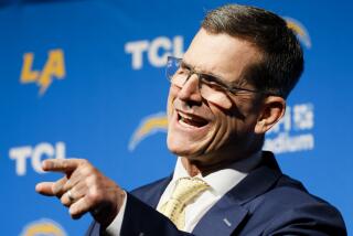 Chargers coach Jim Harbaugh speaks during his introductory press conference.