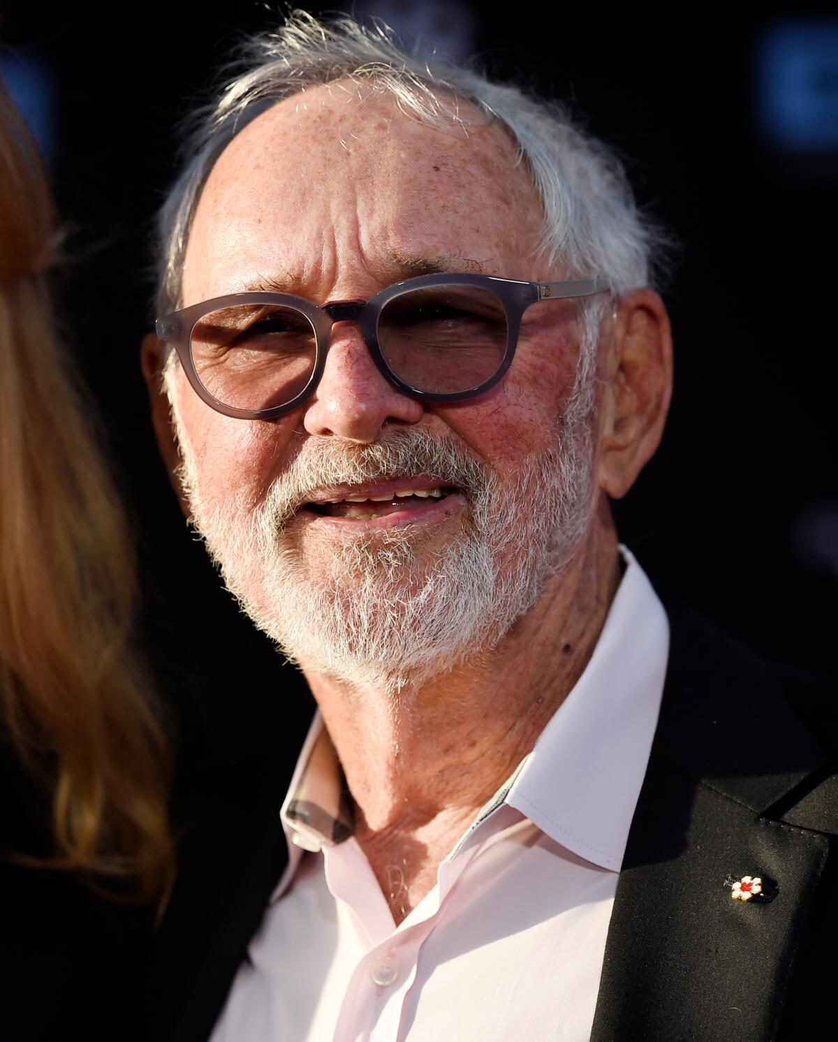 Norman Jewison in sunglasses and a suit without a tie