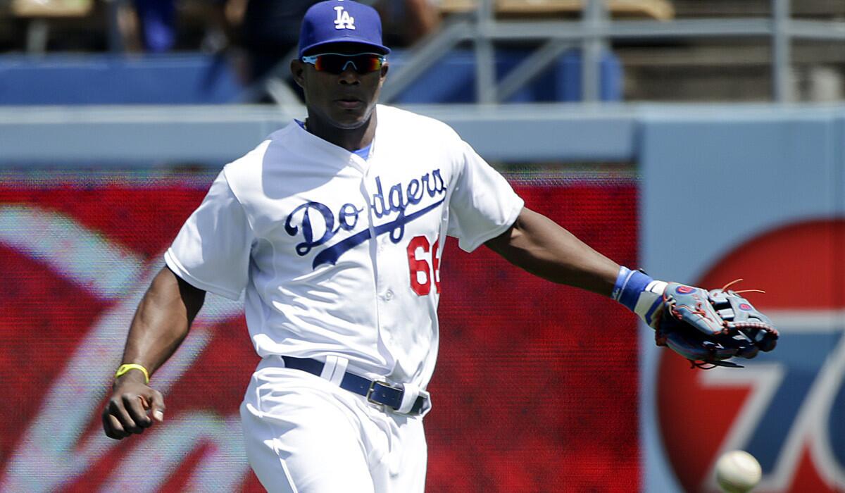 Dodgers outfielder Yasiel Puig tracks down a hit by Nationals shortstop Ian Desmond during a game last week.