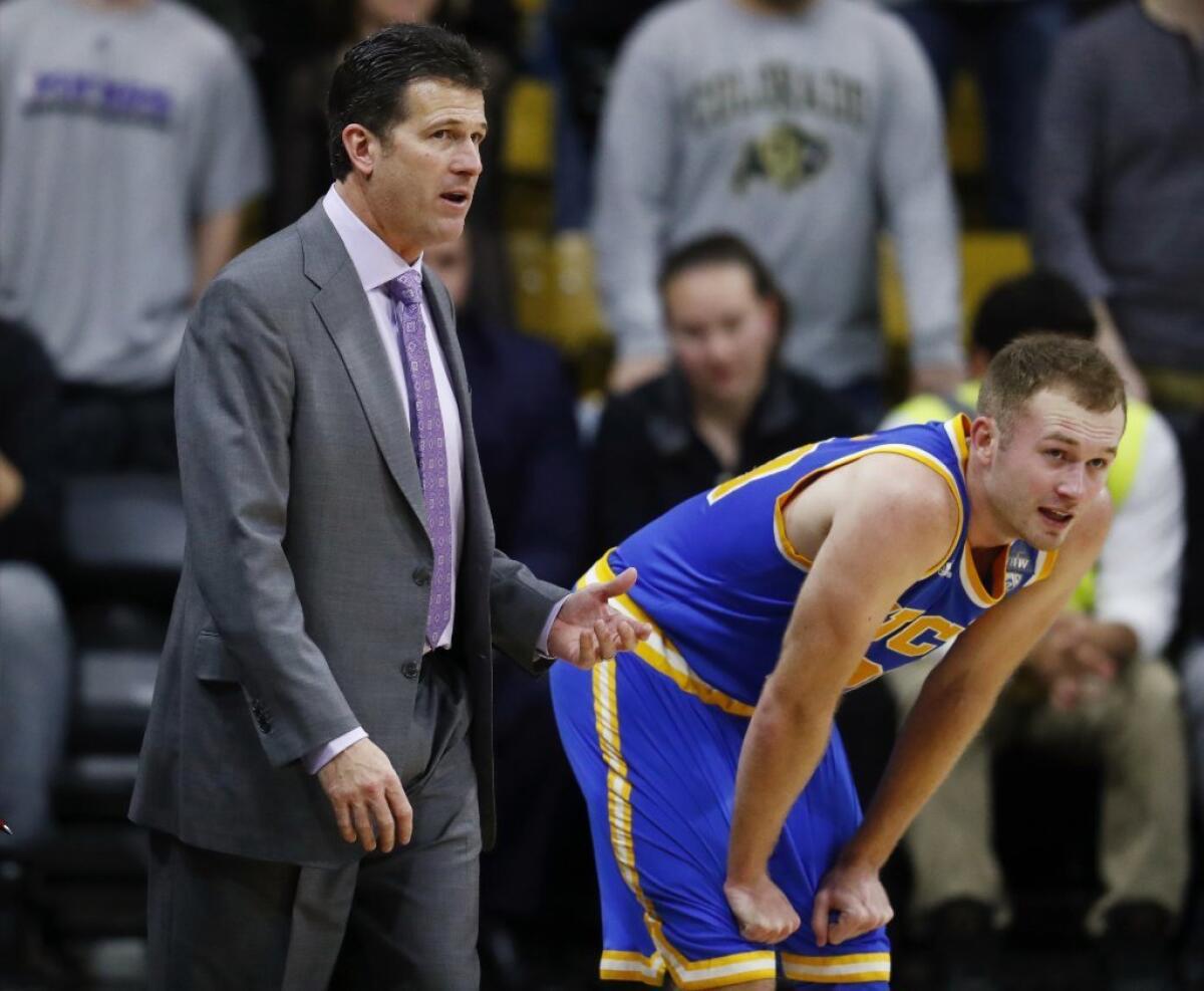 UCLA Coach Steve Alford and his son, Bryce Alford, talk as time runs out during a game against Colorado on Thursday.