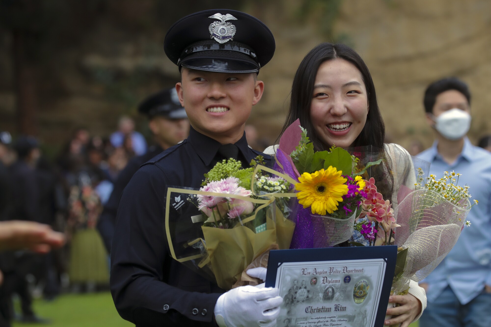 New graduate police officer Christian Kim, left, and his girlfriend Jennifer Yoon after the graduation ceremony.