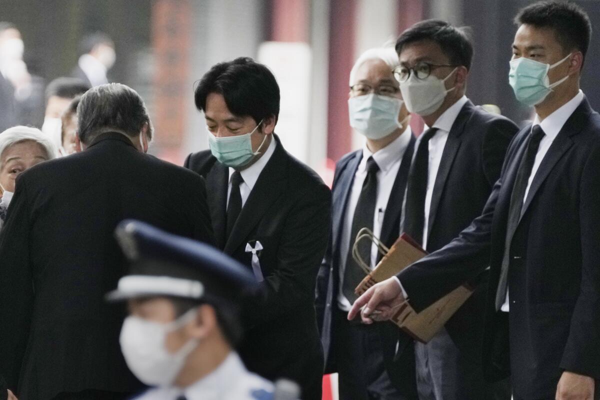 Taiwan's Vice President Lai Ching-te, center, leaves Zojoji temple after the funeral of former Japanese Prime Minister Shinzo Abe in Tokyo on Tuesday, July 12, 2022. Abe was assassinated Friday while campaigning in Nara, western Japan. (AP Photo/Hiro Komae)