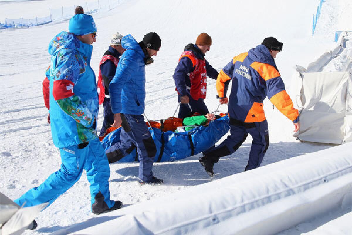 Marika Enne of Finland is taken out by stretcher after crashing on the final jump of the slopestyle course during a training session Tuesday at Rosa Khutor Extreme Park prior to the Sochi 2014 Winter Olympics.