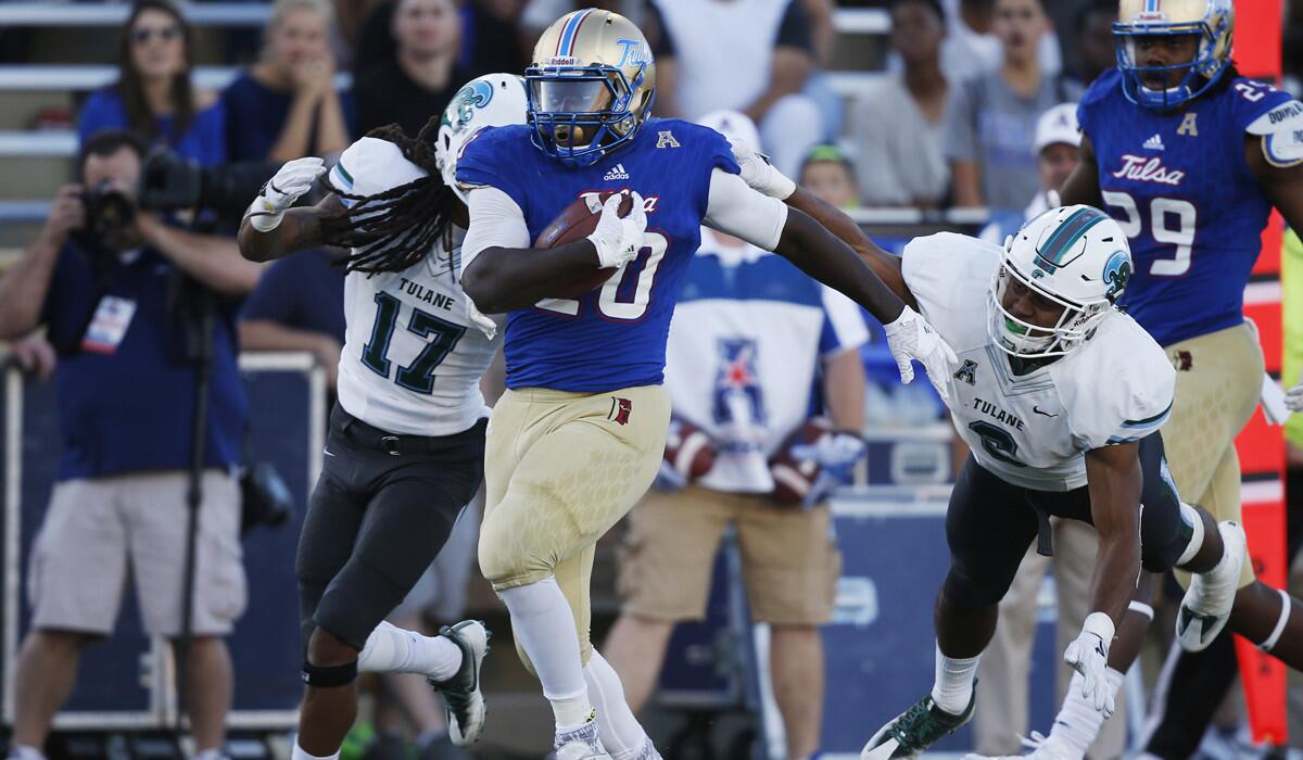 Tulsa running back James Flanders (20) sprints past Tulane defenders for a touchdown in the fourth quarter on Oct. 22. Tulsa will play Central Michigan in the Miami Beach Bowl.